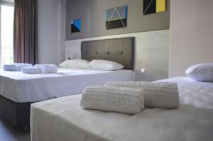 A bed or beds in a room at Enjoy Apartments & Studios