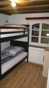 a room with three bunk beds and a window at Gästehaus By George in Stolberg