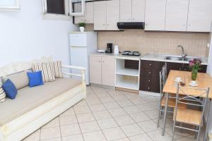 a kitchen with a couch and a table in a room at Little Yard Studios & Apartments #3 in Naxos Chora