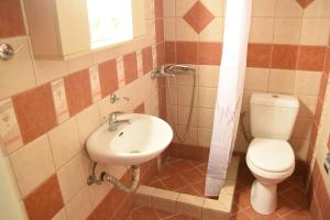 a bathroom with a toilet and a sink at Little Yard Studios & Apartments #3 in Naxos Chora