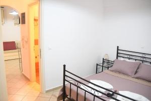 a bedroom with a bed and a hallway at Little Yard Studios & Apartments #3 in Naxos Chora