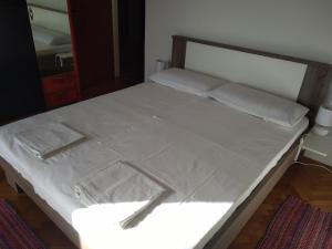 a bed with two pillows on it with at Apartments Pavelić in Crikvenica
