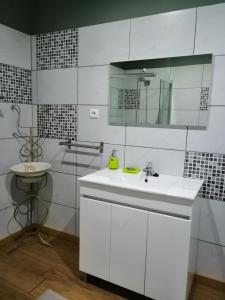 a white bathroom with a sink and a mirror at Casa do Vale de Cerva in Cerva