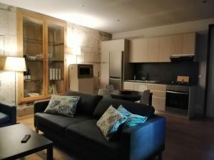 a living room with a couch and a kitchen at Casa do Vale de Cerva in Cerva