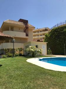 a villa with a swimming pool in front of a building at Casaberian Manilva Beach Estepona, Marbella, Malaga, SPAIN in Manilva