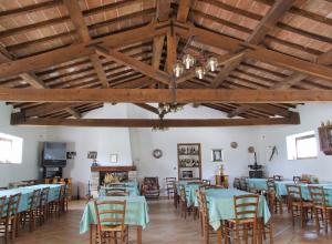 a dining room with blue tables and chairs at Agriturismo Casella Del Piano in Gubbio