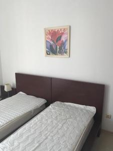 a bedroom with two beds and a painting on the wall at Sun Village Villa 13 in Byala +24 photos