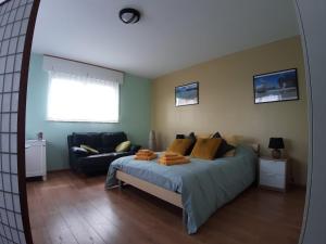a bedroom with a bed and a couch at COSY B&B 2B in Overijse