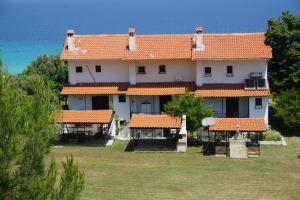 a large house with an orange tile roof at Danae's holiday home in Polychrono