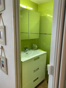 a green bathroom with a sink and a mirror at Villa Entre Encinas in Moralina +68 photos