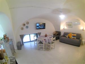 a living room with a table and a couch at Landolina Sweet Home in Catania