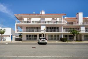 a car parked in front of a building at AL Cabanas de Tavira in Cabanas de Tavira