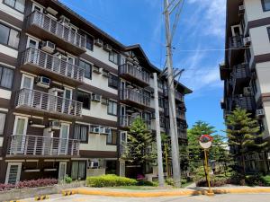 an apartment building with balconies and a street sign at Solano Hills-1 bedroom unit in Manila