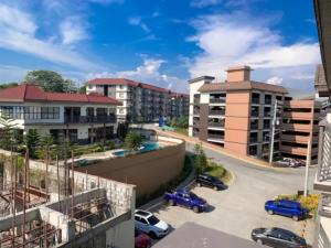 a view of a city with cars parked in a parking lot at Solano Hills-1 bedroom unit in Manila