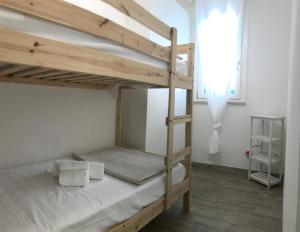 a bedroom with two bunk beds and a window at Favignana Holidays in Favignana