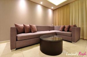 a living room with a couch and a table at Louloudis Fresh-Adults Only in Skala Rachoniou
