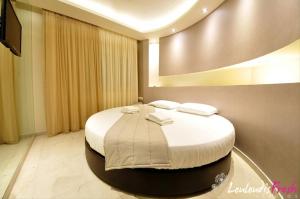 a bedroom with a large bed with towels on it at Louloudis Fresh-Adults Only in Skala Rachoniou