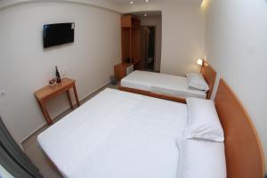 Postel nebo postele na pokoji v ubytování Hotel Ari 2