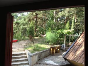 a view of a yard with a hammock and a patio at Apartments Melnalkšņi in Saulkrasti