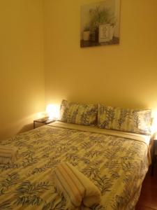 a bedroom with a bed with two pillows at Rooms 4 you - Small Yellow room in Portimão