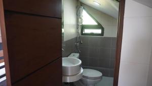 a bathroom with a toilet and a sink at MG Holiday Home Tagaytay in Tagaytay +32 photos