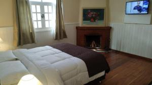Ένα ή περισσότερα κρεβάτια σε δωμάτιο στο Refúgio das Rosas