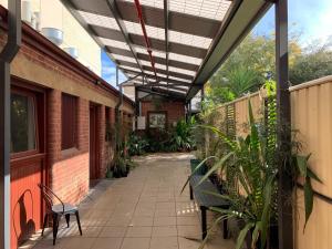 a patio with benches and awning on a building at CROWN CENTRAL BUSINESS DISTRICT MOTEL - NO UNDER 18s in Bendigo