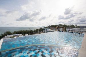 a large swimming pool on top of a building at Grandbeach2 B52 By malai in Mae Pim