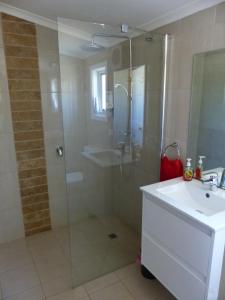 a bathroom with a shower and a sink at Andy's Accommodation in Peterborough