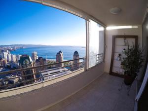 a balcony with a view of the city and the ocean at Departamentos Alto Libertad in Viña del Mar