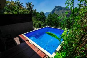 a swimming pool with a view of a mountain at Ella Flower Garden Resort in Ella