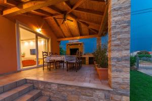 a patio with a table and chairs on it at Bella Casa in Sukošan