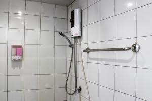 a shower with a phone on a tiled wall at 3 Laan House in Chiang Mai +59 photos