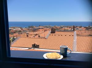 a table with a plate of food and a cup of coffee at Blue Apartment in Sanremo