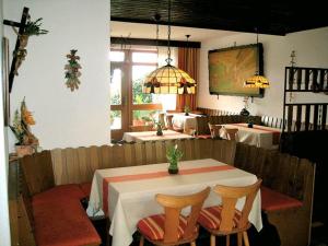 a dining room with a table and two tables at Marias Pension in Falkenstein