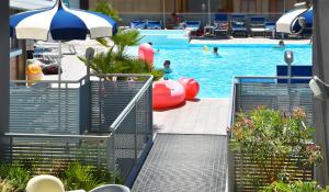 a swimming pool with a red inflatable at Hotel Bristol in Caorle