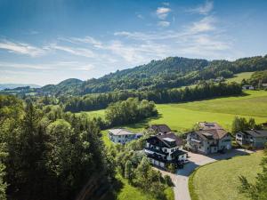 an aerial view of a house in the hills at Pension Nocksteinblick in Salzburg