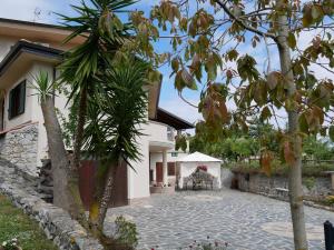 a courtyard of a house with trees and a building at B & B Korello in Gasponi