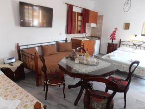 a bedroom with a bed and a table and a bed at Villa Elizea in Stalos