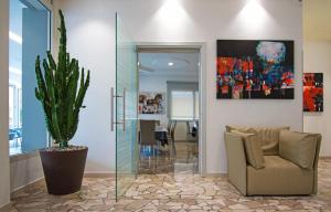 a living room with a couch and a potted plant at Hotel Bristol in Caorle
