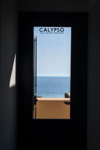 a door with a view of the ocean through it at Villa calypso Pantelleria in Pantelleria