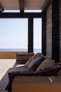 a bedroom with a bed with a large window at Villa calypso Pantelleria in Pantelleria
