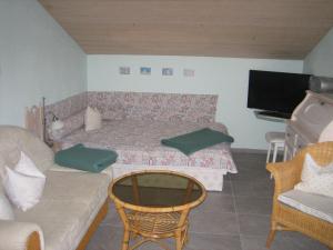 a living room with a bed and a couch at Haus Osterried in Schwangau