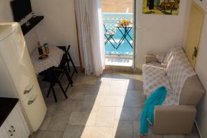a view of a living room with a table and a window at Kleio House in Astypalaia