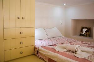 a bedroom with a bed and a dresser at Kleio House in Astypalaia