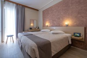 a hotel room with a large bed and a window at Acropolis View Hotel in Athens