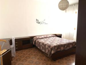 Ένα ή περισσότερα κρεβάτια σε δωμάτιο στο Appartamento Vacanze sul Lungomare Amerigo Vespucci