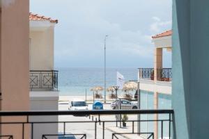 a view of the ocean from a balcony at Ikies Luxury Apartments in Ofrínion