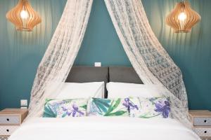 a bedroom with a bed with a canopy at Ikies Luxury Apartments in Ofrínion