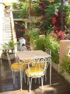 a table and chairs on a patio with flowers at Riad Malika in Marrakesh